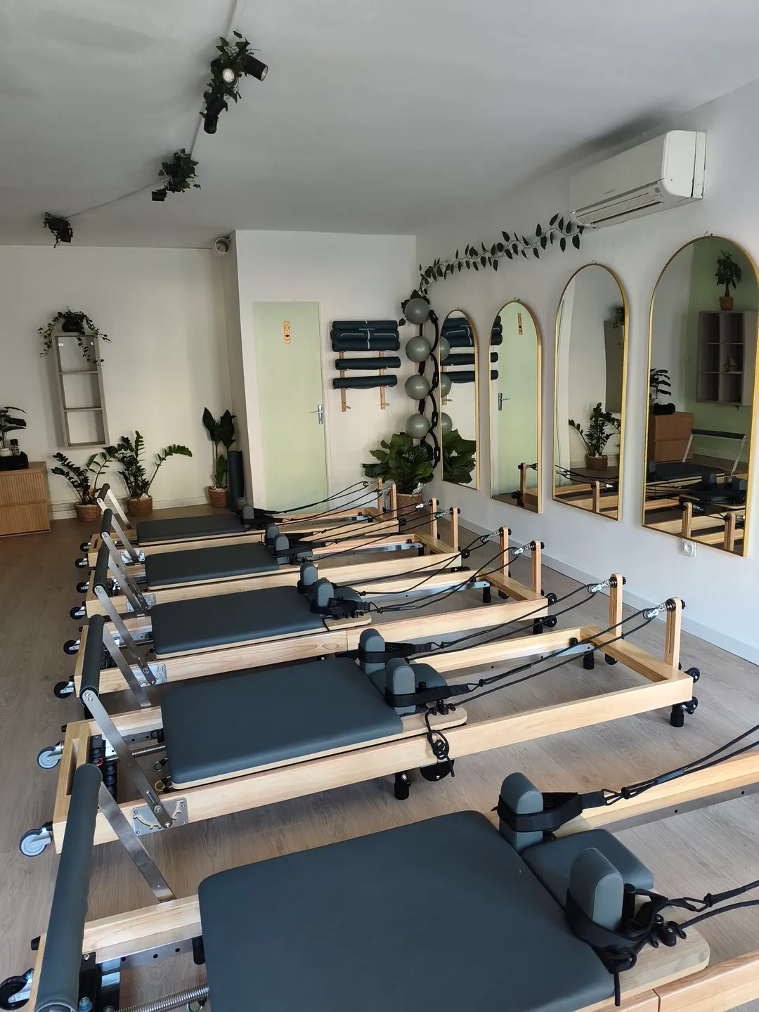 Femme réalisant un exercice de Pilates Reformer sur une machine à ressorts